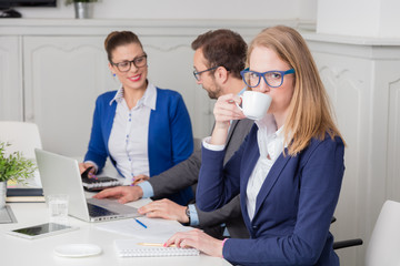 Fototapeta premium Portrait of a young businesswoman drinking coffee during the meeting 