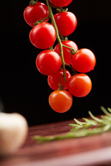 cherry tomatoes on a black background