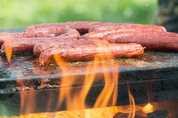 Roasting sausages on fire