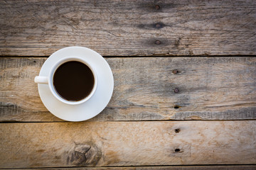 cup of coffee on wood table background