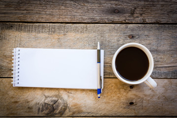 cup of coffee  with paper note on wood table background