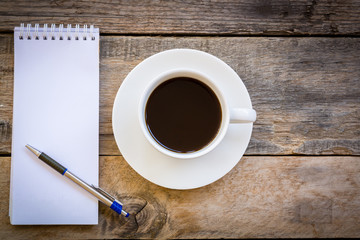 cup of coffee  with paper note on wood table background