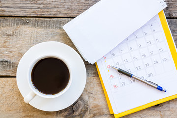 cup of coffee  with paper note on wood table background