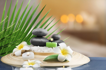 Composition with spa stones and flowers on blurred  background