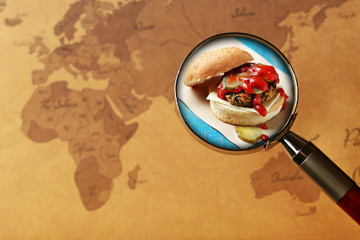Popular food concept. Looking for sandwich on world map