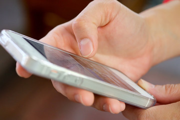 Close-up of hand of woman using mobile smart phones.