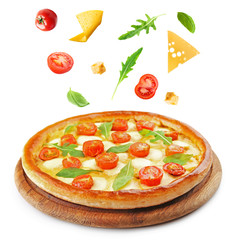 Pizza with falling ingredients, isolated on white