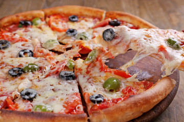 Pizza with cheese on board and wooden table background