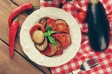 Ratatouille on plate, on table background