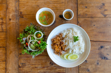 Pork fried with garlic and rice in white disk