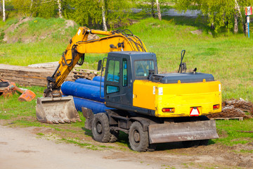 A big yellow excavator at construction site.