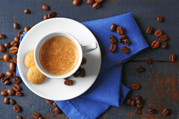 Cup of coffee on wooden table background