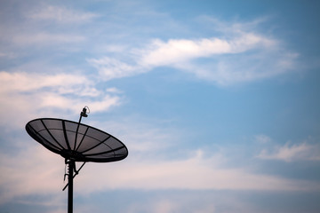 Satellite dish on the blue sky background.