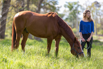 Girl and horse in field