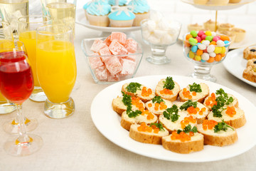 Set of cold snacks, canape, beverages and dessert, closeup