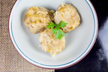 Chinese yum cha, pork dumpling Shumai in white bowl.