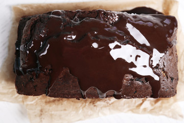 Chocolate cake with icing on white table