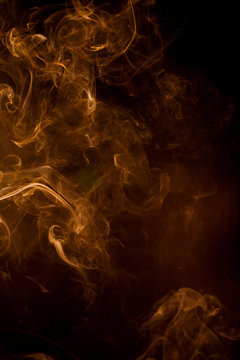 Orange smoke on a black background.