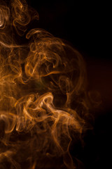 Orange smoke on a black background.