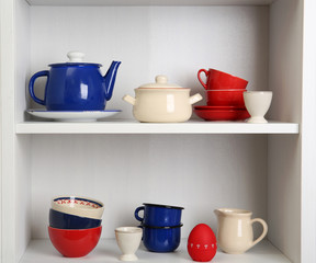 Tableware on shelves in the kitchen cupboard