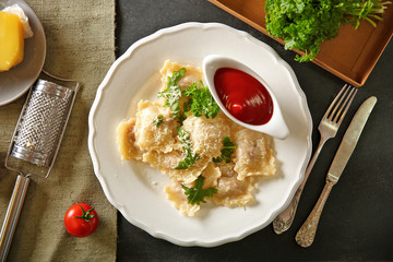Cooked ravioli with tomato sauce on plat