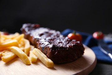 Grilled steak with french fries and cherry tomatoes, closeup