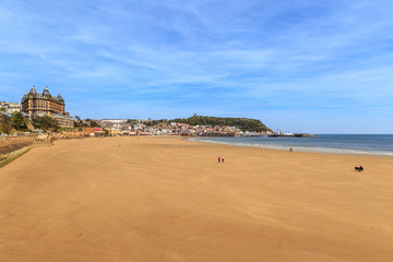 Fototapeta na wymiar Various people on the beach. In Scarborough, England. On 5th May 2016.