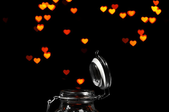 Miracle of love from glass jar on black background