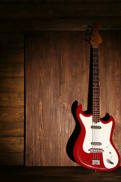 Electric guitar on dark lightened wooden background