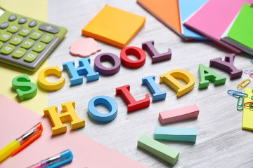 Set of stationery with alphabet on white wooden table