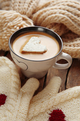 Cup of coffee with marshmallow on wooden table