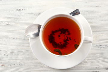 Cup of tea on white table, top view