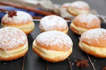 Fresh homemade donuts with powdered sugar, close up