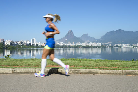 Athletic woman jogging at Lagoa Rodrigo de Freitas lagoon, Rio de Janeiro, Brazil