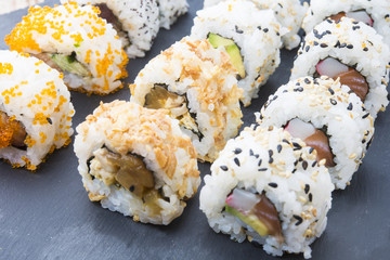 Sushi rolls on a slate plate