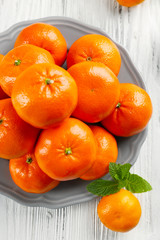 Pile of mandarin on light wooden background