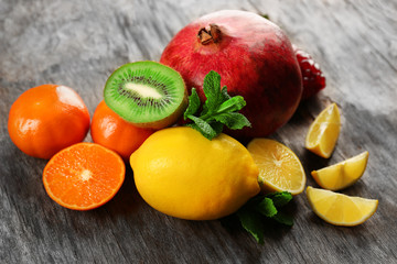 Juicy composition of tropical fruits on wooden background