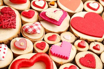 Set of different craft hearts on wooden logs