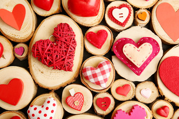 Set of different craft hearts on wooden logs