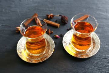 Glass cups of tea with cinnamon and lemon on the table
