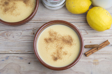 Traditional creme brulee on ceramic dish on wooden table