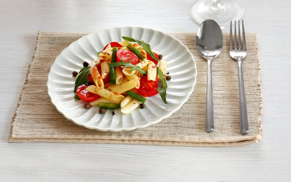 Boiled Penne Pasta With Tomatoes, French Bean And Arugula On White Plate