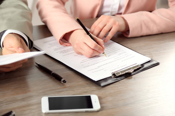 Human hands working with documents at the desk closeup