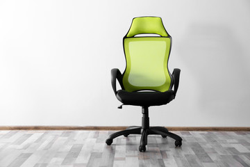New office chair in front of wall background