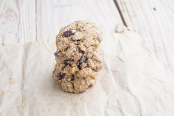 Chocolate cookies on white linen napkin on wooden table