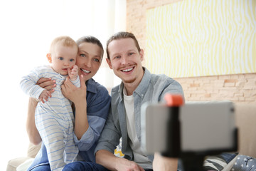 Happy couple taking a selfie with baby , close up