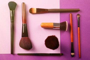 Collection of professional makeup brush on purple background