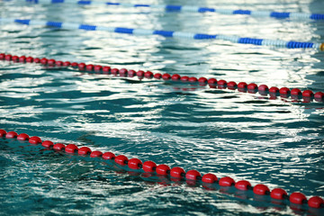 Background of water and markers in the swimming pool, close-up