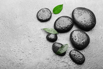 Heap of spa hot stones on grey background