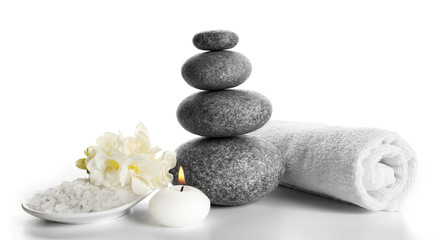 Fototapeta na wymiar Spa still life with pebbles and candlelight isolated on white